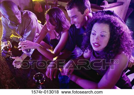 Close-up of two young couples at a bar View Large Photo Image Stock Photo - Close-up of two young couples at a bar. Fotosearch