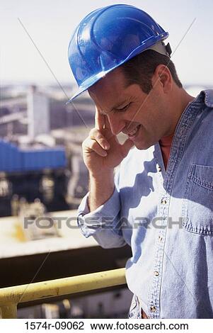 Construction worker touching his head looking down View Large Photo Image Stock Image - Construction worker touching his head looking down. Fotosearch