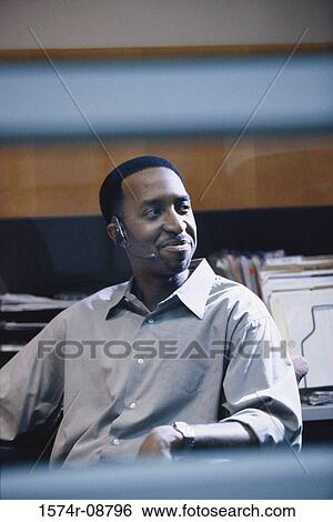 Customer service representative wearing a headset smiling View Large Photo Image Stock Photograph - Customer service representative wearing a headset smiling. Fotosearch