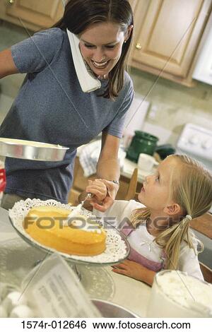 Daughter helping her mother bake a cake View Large Photo Image Stock Photograph - Daughter helping her mother bake a cake. Fotosearch