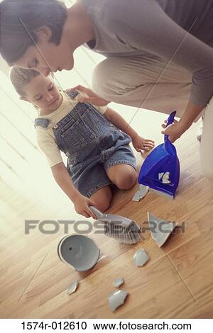 Daughter helping her mother sweep up pieces of broken crockery off the floor View Large Photo Image Stock Image - Daughter helping her mother sweep up pieces of broken crockery off the floor. Fotosearch