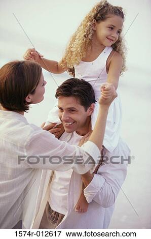 Stock Photo - Daughter sitting on her father's shoulder. Fotosearch