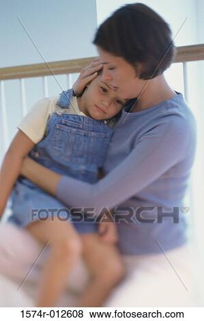 Stock Photo - Daughter sitting on her mother's lap. Fotosearch