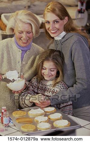 Daughter with her mother and grandmother preparing cookies View Large Photo Image Stock Image - Daughter with her mother and grandmother preparing cookies. Fotosearch