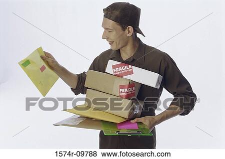 Stock Photo - Delivery man holding delivery packages. Fotosearch