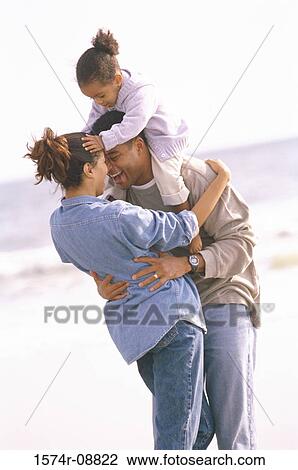 Father and mother playing with their daughter on the beach View Large Photo Image Stock Image - Father and mother playing with their daughter on the beach. Fotosearch