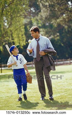 Father and son walking in a park View Large Photo Image Stock Image - Father and son walking in a park. Fotosearch