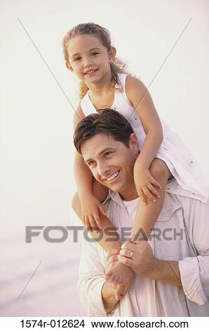 Father carrying his daughter on his shoulders View Large Photo Image Picture - Father carrying his daughter on his shoulders. Fotosearch
