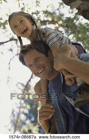 Father carrying his daughter on his shoulders View Large Photo Image Stock Image - Father carrying his daughter on his shoulders. Fotosearch