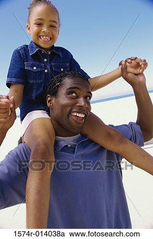 Father carrying his daughter on the beach View Large Photo Image Stock Image - Father carrying his daughter on the beach. Fotosearch