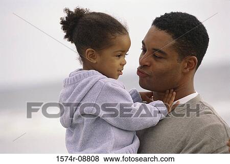 Father carrying his daughter View Large Photo Image Stock Photo - Father carrying his daughter. Fotosearch