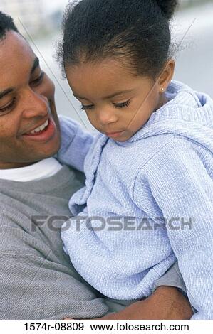 Stock Photo - Father carrying his daughter. Fotosearch