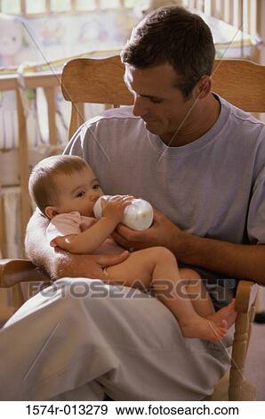 Stock Photo - Father feeding his daughter. Fotosearch