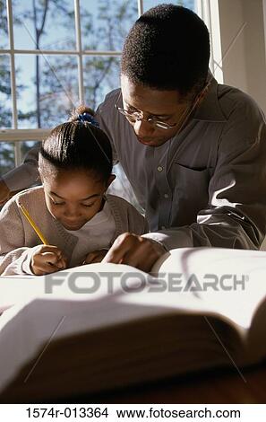 Father helping his daughter with her homework View Large Photo Image Picture - Father helping his daughter with her homework. Fotosearch