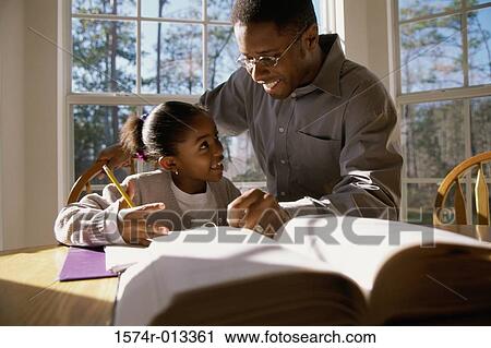 Father helping his daughter with her homework View Large Photo Image Stock Image - Father helping his daughter with her homework. Fotosearch