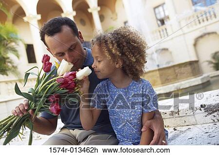 Father holding a bouquet of flowers with his daughter View Large Photo Image Stock Image - Father holding a bouquet of flowers with his daughter. Fotosearch