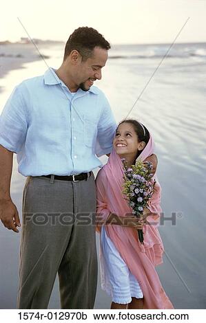 Father walking with his daughter on the beach View Large Photo Image Stock Image - Father walking with his daughter on the beach. Fotosearch