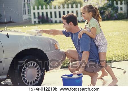 Father washing his car with his daughter leaning on him View Large Photo Image Stock Image - Father washing his car with his daughter leaning on him. Fotosearch