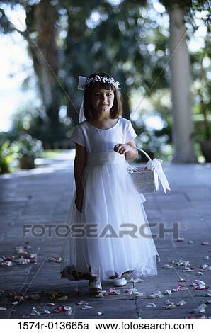 Flower girl walking with a flower basket View Large Photo Image Stock Image - Flower girl walking with a flower basket. Fotosearch