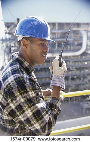 Stock Photo - Foreman talking on a walkie-talkie. Fotosearch