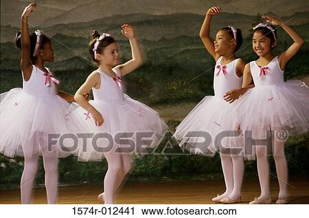 Stock Image - Four ballet dancers dancing with their hands raised. Fotosearch