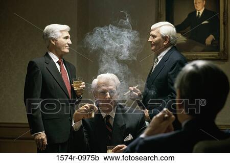 Four businessmen smoking cigars in an office View Large Photo Image Stock Image - Four businessmen smoking cigars in an office. Fotosearch