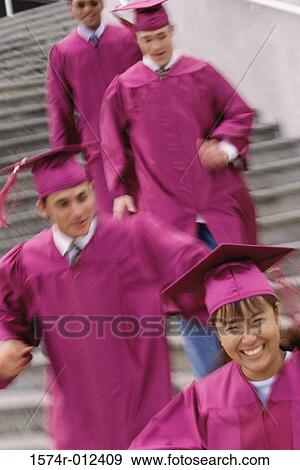 Four young graduates walking downstairs View Large Photo Image Stock Photo - Four young graduates walking downstairs. Fotosearch