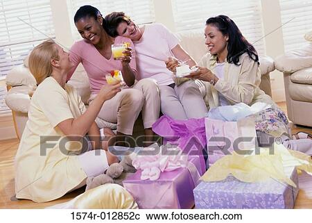 Stock Image - Four young women at a baby shower. Fotosearch