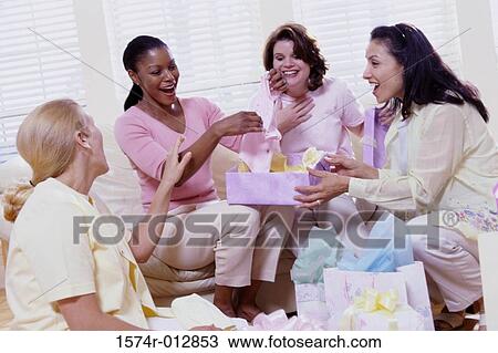 Four young women sitting together at a baby shower View Large Photo Image Stock Image - Four young women sitting together at a baby shower. Fotosearch