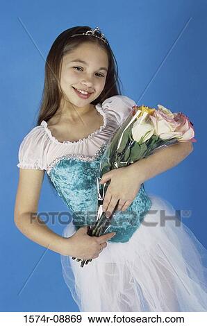 Girl in a ballerina outfit holding a bouquet of flowers View Large Photo Image Stock Photo - Girl in a ballerina outfit holding a bouquet of flowers. Fotosearch