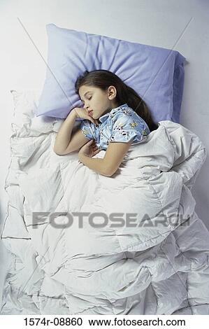 Stock Image - Girl sleeping on a bed. Fotosearch