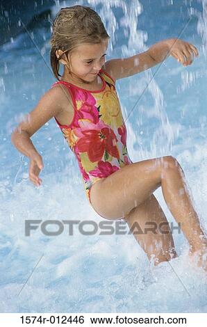 Girl splashing water in a swimming pool View Large Photo Image Stock Photograph - Girl splashing water in a swimming pool. Fotosearch