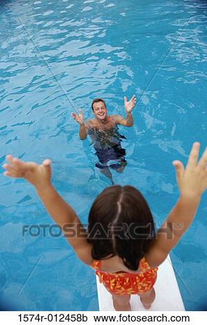 Stock Image - Girl standing on a diving board. Fotosearch
