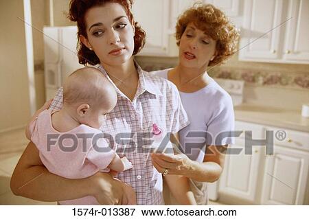Grandmother giving a milk bottle to her daughter and granddaughter View Large Photo Image Stock Photo - Grandmother giving a milk bottle to her daughter and granddaughter. Fotosearch