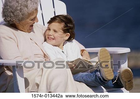 Grandmother sitting with her granddaughter and smiling View Large Photo Image Stock Image - Grandmother sitting with her granddaughter and smiling. Fotosearch