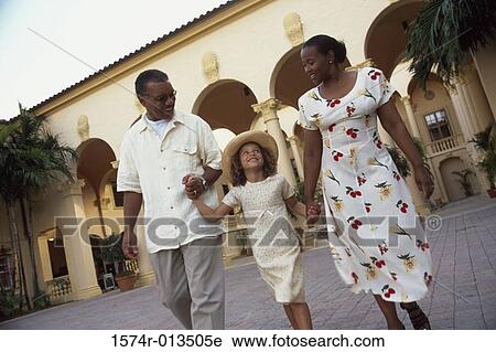 Grandparents walking with their granddaughter View Large Photo Image Stock Image - Grandparents walking with their granddaughter. Fotosearch