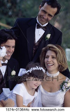 Stock Image - Groom with wedding guests and a flower girl. Fotosearch