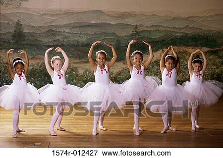 Stock Photo - Group of ballet dancers dancing with their arms raised. Fotosearch