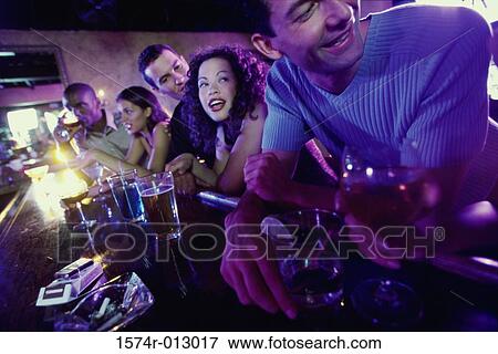 Group of people at a bar View Large Photo Image Stock Photo - Group of people at a bar. Fotosearch