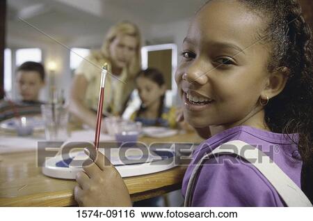 Group of school children painting on a table View Large Photo Image Stock Photograph - Group of school children painting on a table. Fotosearch