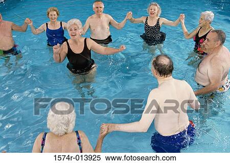 Stock Photography - Group of senior people performing water aerobics in a swimming pool. Fotosearch