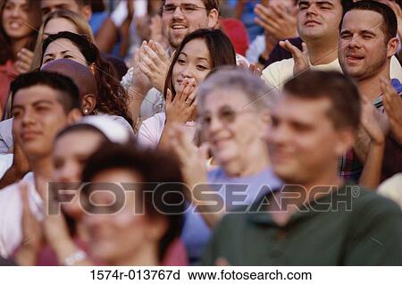 Group of spectators applauding in a stadium View Large Photo Image Stock Image - Group of spectators applauding in a stadium. Fotosearch
