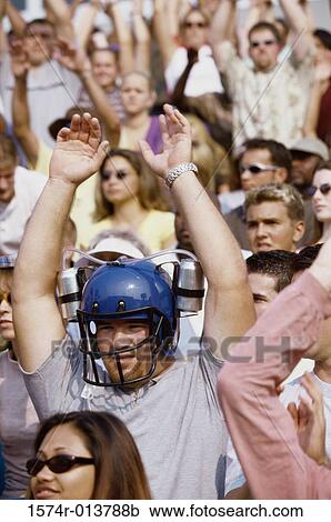 Stock Image - Group of spectators applauding in a stadium. Fotosearch