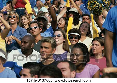 Stock Image - Group of spectators cheering in a stadium. Fotosearch