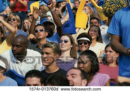 Stock Image - Group of spectators cheering in a stadium. Fotosearch