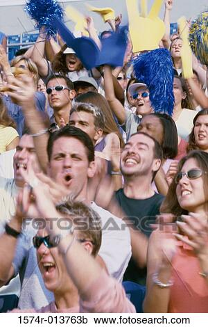 Group of spectators cheering in a stadium View Large Photo Image Stock Image - Group of spectators cheering in a stadium. Fotosearch