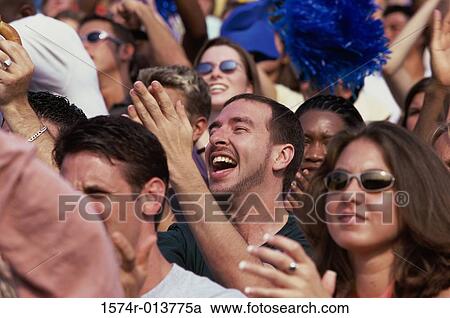 Group of spectators cheering in a stadium View Large Photo Image Stock Image - Group of spectators cheering in a stadium. Fotosearch