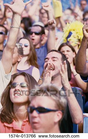 Group of spectators cheering in a stadium View Large Photo Image Stock Photograph - Group of spectators cheering in a stadium. Fotosearch