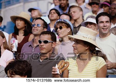 Stock Image - Group of spectators sitting in a stadium. Fotosearch