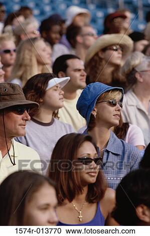Group of spectators sitting in a stadium View Large Photo Image Stock Image - Group of spectators sitting in a stadium. Fotosearch